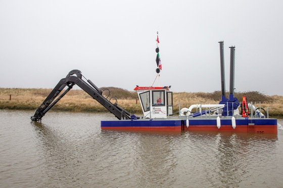 A Goodchild Marine dredger is floating in a body of water.