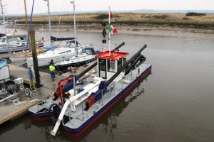 A Goodchild Marine boat docked next to a dock.