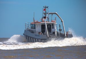 A Goodchild Marine boat is gracefully traveling through the water.
