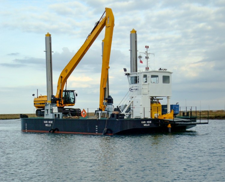 A Goodchild Marine boat with a crane on it in the water.