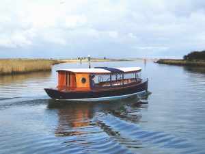 A Goodchild Marine boat is traveling down a body of water.