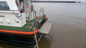 A Goodchild Marine boat docked in the water near a dock.
