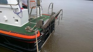 A Goodchild Marine boat with an orange and black deck on it.