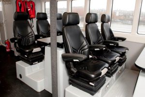 Goodchild Marine: A row of black seats in a boat.