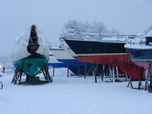 A group of boats by Goodchild Marine in the snow.
