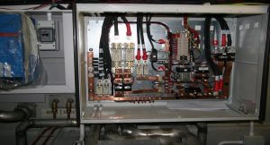 A Goodchild Marine box with a lot of wires in it.