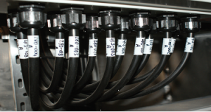 A group of hoses with Goodchild Marine labels attached to them.
