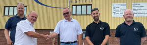 A group of men from Goodchild Marine standing in front of a building.